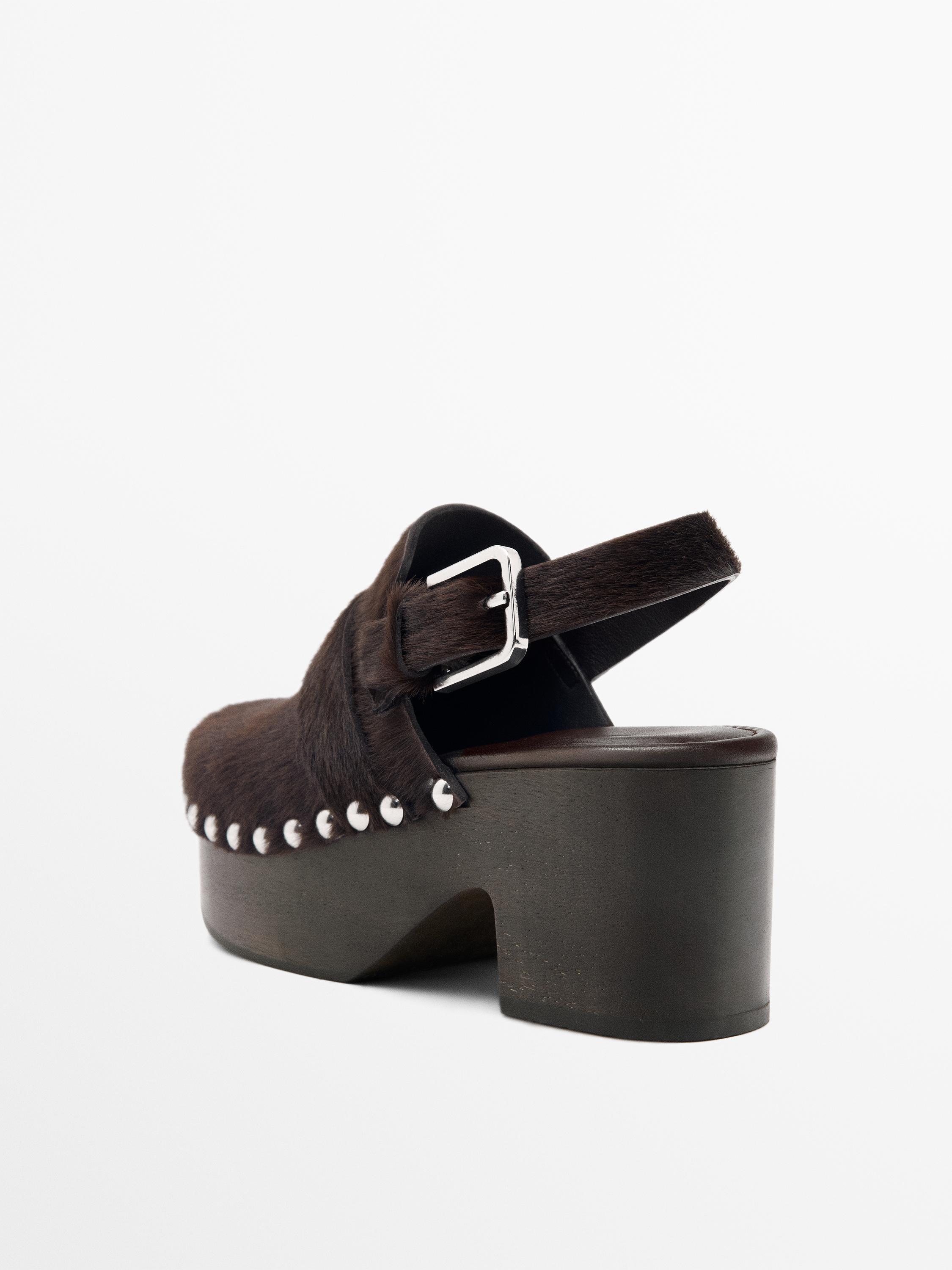 Hair on leather clogs with wooden sole